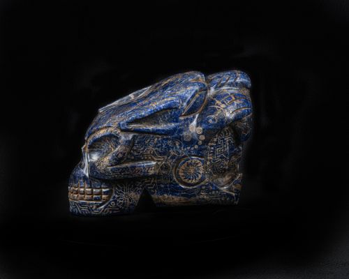 A skull that is blue and brown against a black background